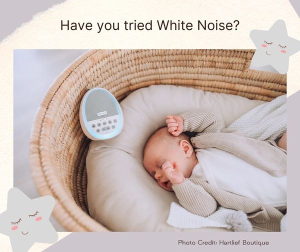 Baby in moses basket sleeping with white noise maker